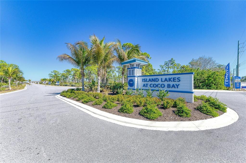 A sign for Island Lakes at Coco Bay stands at the entrance of a road — 8682 SEASALT LOOP, ENGLEWOOD, FL