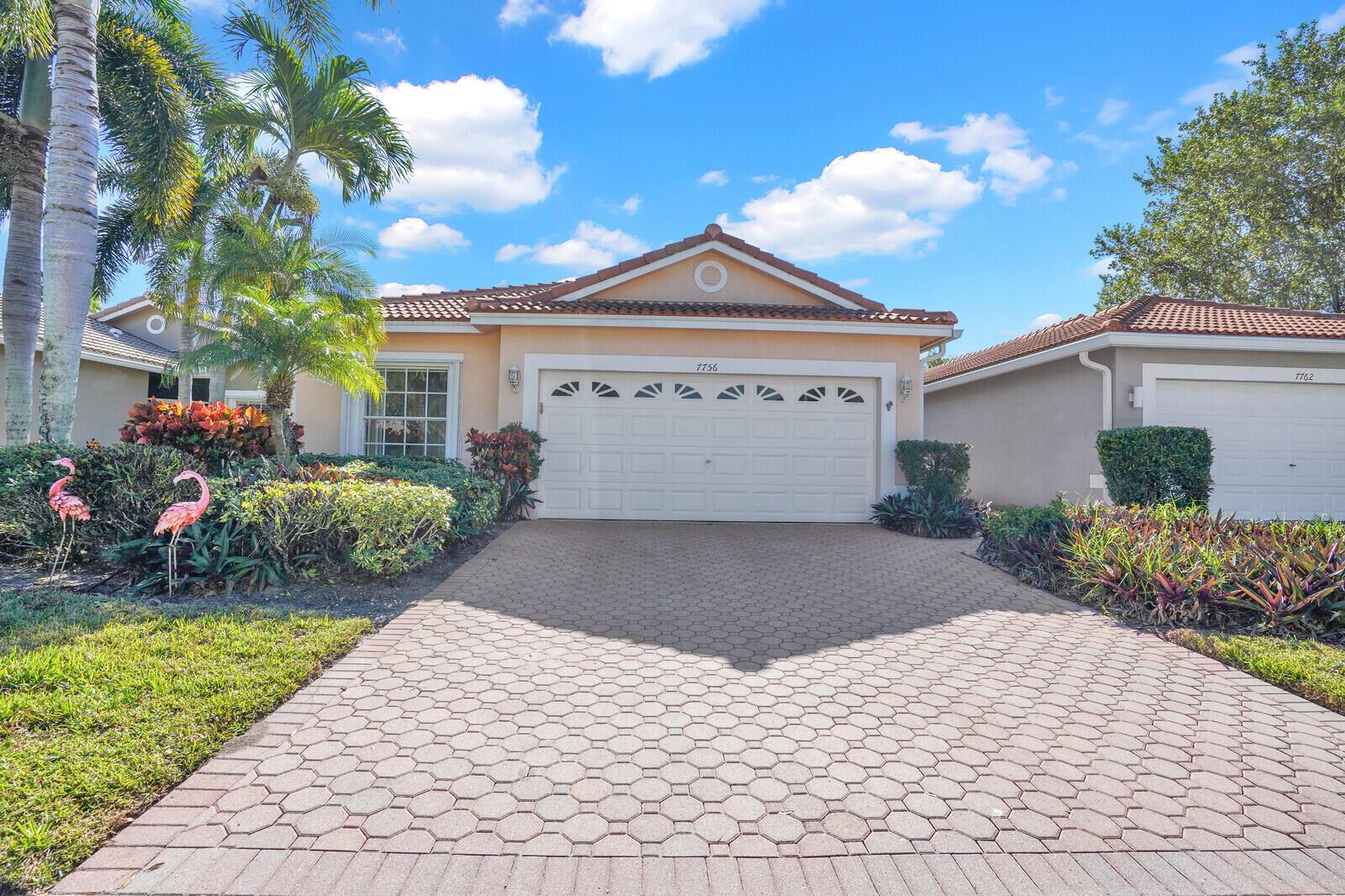 A single-story house with a beige stucco exterior, a tiled roof, and a paved driveway — 7756 Cherry Blossom Way, Boynton Beach FL 33437, BOYNTON BEACH, FL