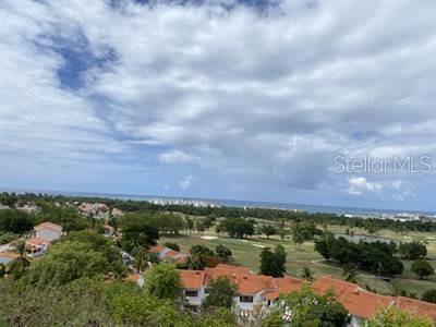 An elevated view of a golf course, residential buildings, and the ocean under a cloudy sky — 6000 RIO MAR BOULEVARD Lot 53, RIO GRANDE, PR