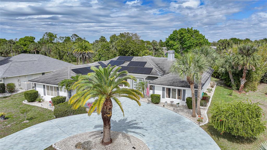An aerial view of a single-story house with solar panels on a tiled roof — 194 MARACAL WAY, PUNTA GORDA, FL