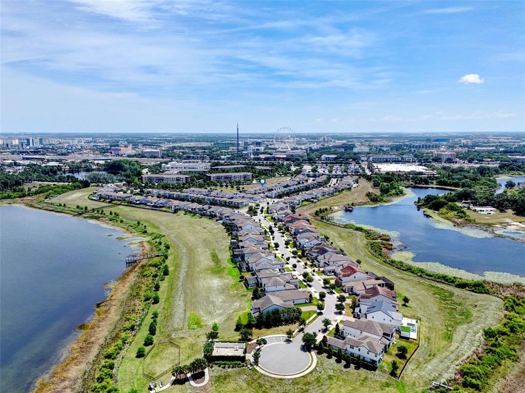 An aerial view shows a suburban residential neighborhood situated between two lakes — 7043 CARRICKBEND LANE, ORLANDO, FL