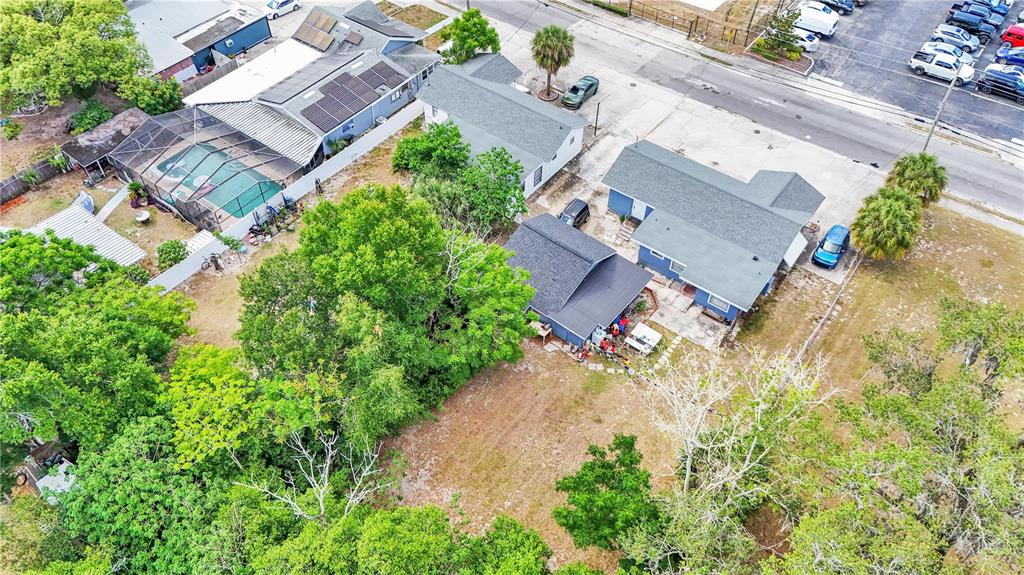 An aerial view shows several houses with roofs, a swimming pool, and surrounding trees — 26 W POLK AVENUE, LAKE WALES, FL