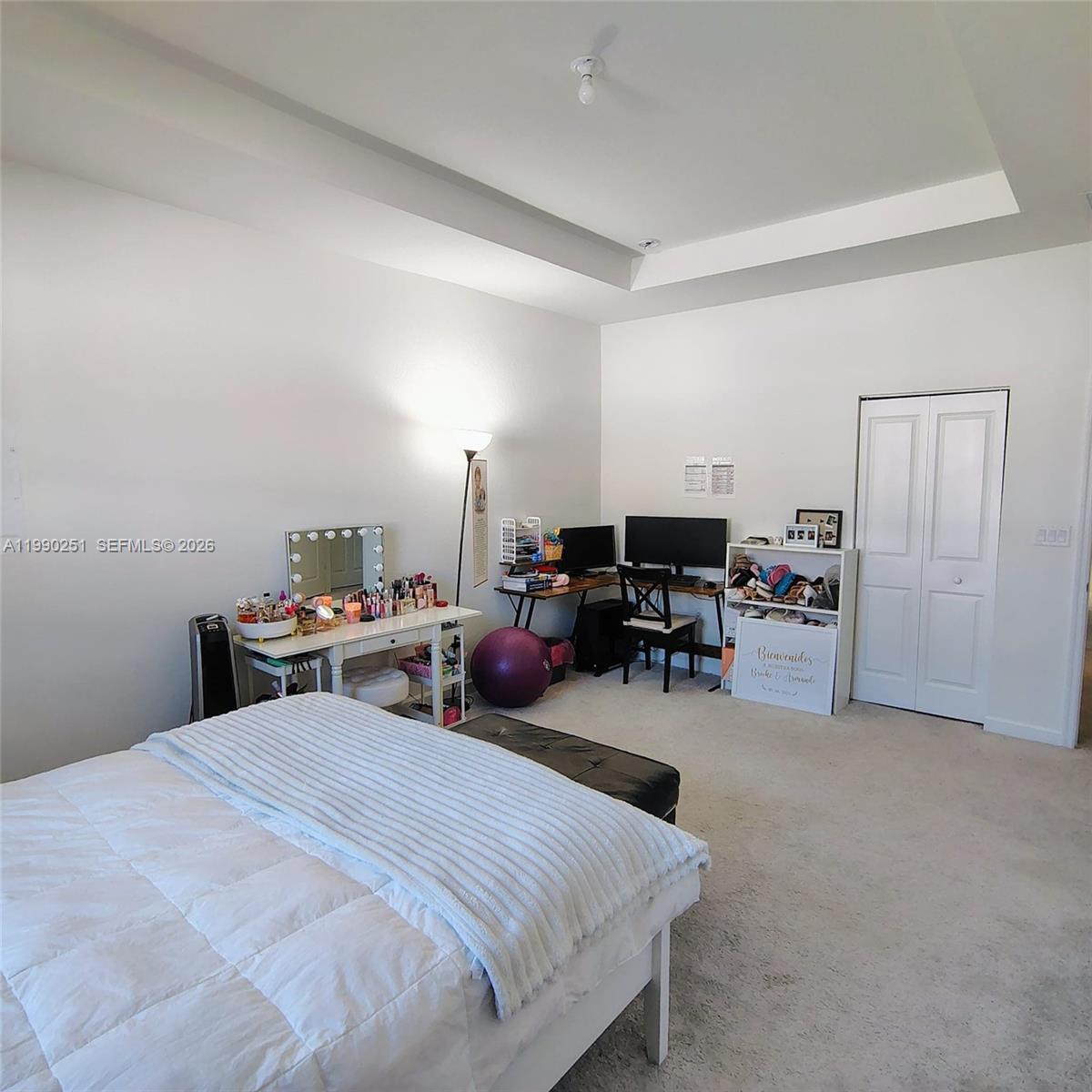 A bedroom features a white bed, a vanity, a computer desk, and a closet — 23074 SW 128th Pl, Goulds FL 33170, GOULDS, FL