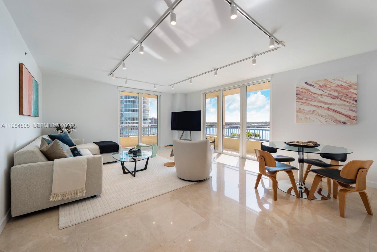 A high-angle view shows a marina, cruise ships, and the Miami skyline under a blue sky — 90 Alton Rd # 902, Miami Beach FL 33139, MIAMI BEACH, FL