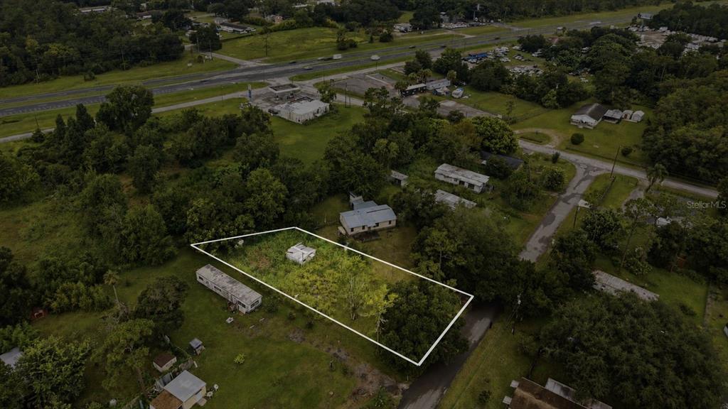 An aerial view shows a rectangular lot outlined in white containing a small structure — 18052 2ND AVENUE, ORLANDO, FL