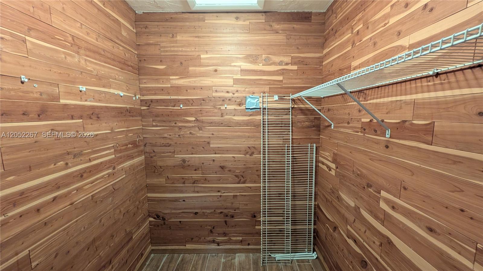 A walk-in closet features cedar-paneled walls and a wire shelving unit — 315 SE 23rd Ave # 5, Pompano Beach FL 33062, POMPANO BEACH, FL