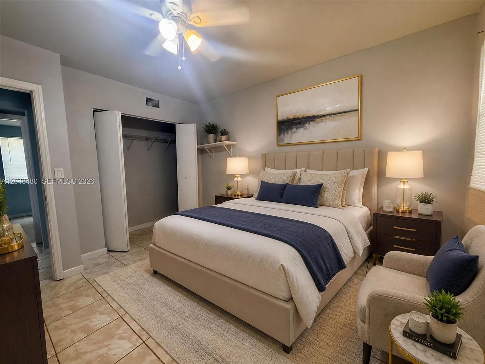 A bedroom features a queen bed, two nightstands, a closet, and a small armchair — 14240 NW 22nd Ave # 1, Opa-Locka FL 33054, OPA-LOCKA, FL