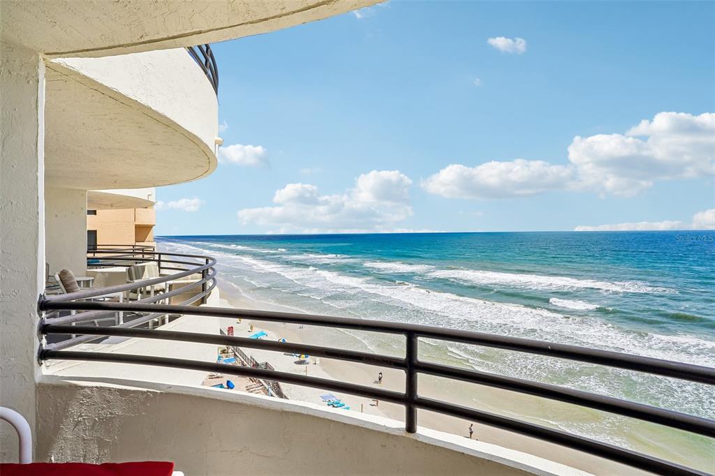 A view from a curved balcony overlooking a sandy beach and the ocean — 3115 S ATLANTIC AVENUE UNIT G030, DAYTONA BEACH, FL