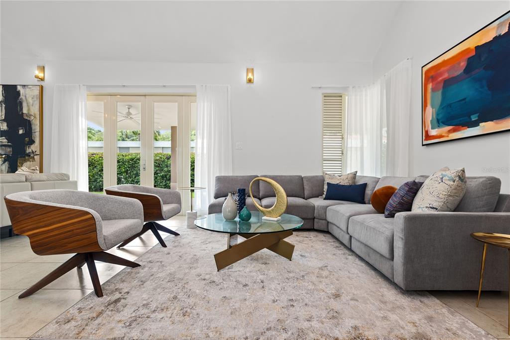 A living room features a grey sectional sofa, two mid-century modern chairs, and a glass-topped table — 418 CAMINO DEL SUSUA, DORADO, PR