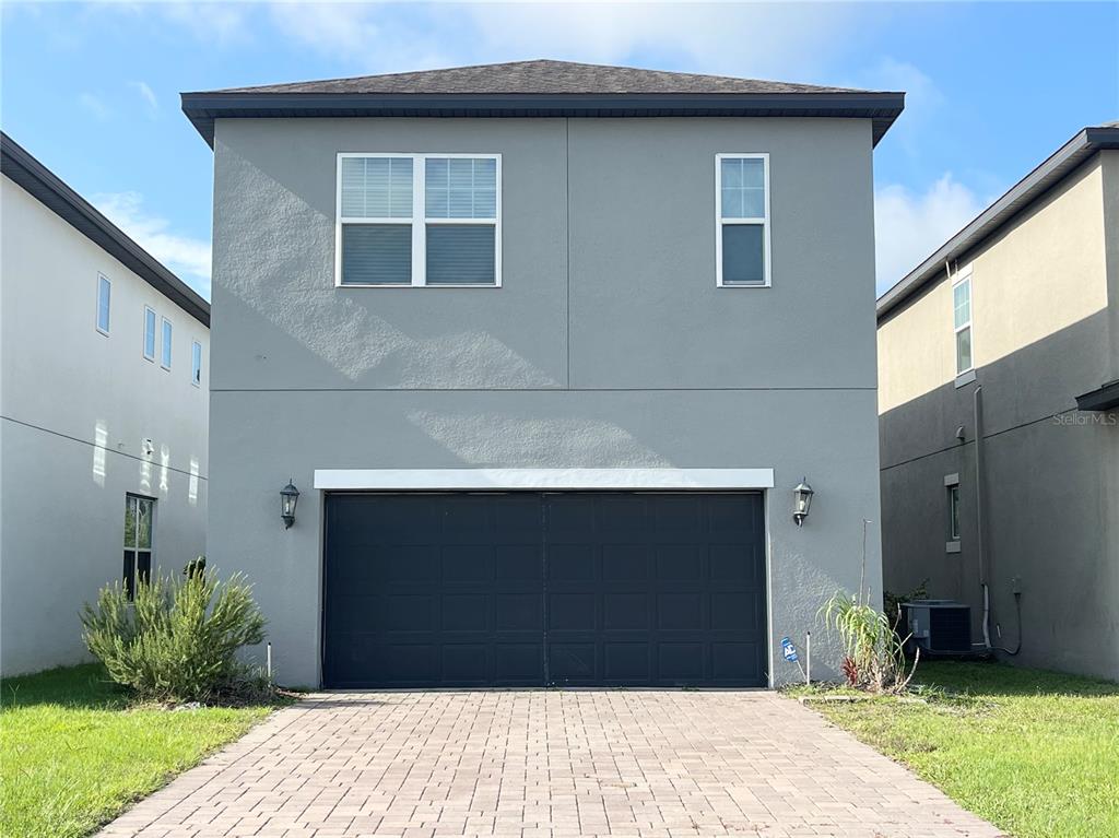 A two-story house with a gray exterior, a two-car garage, and a paved driveway — 15060 WILLOW ARBOR CIRCLE, ORLANDO, FL