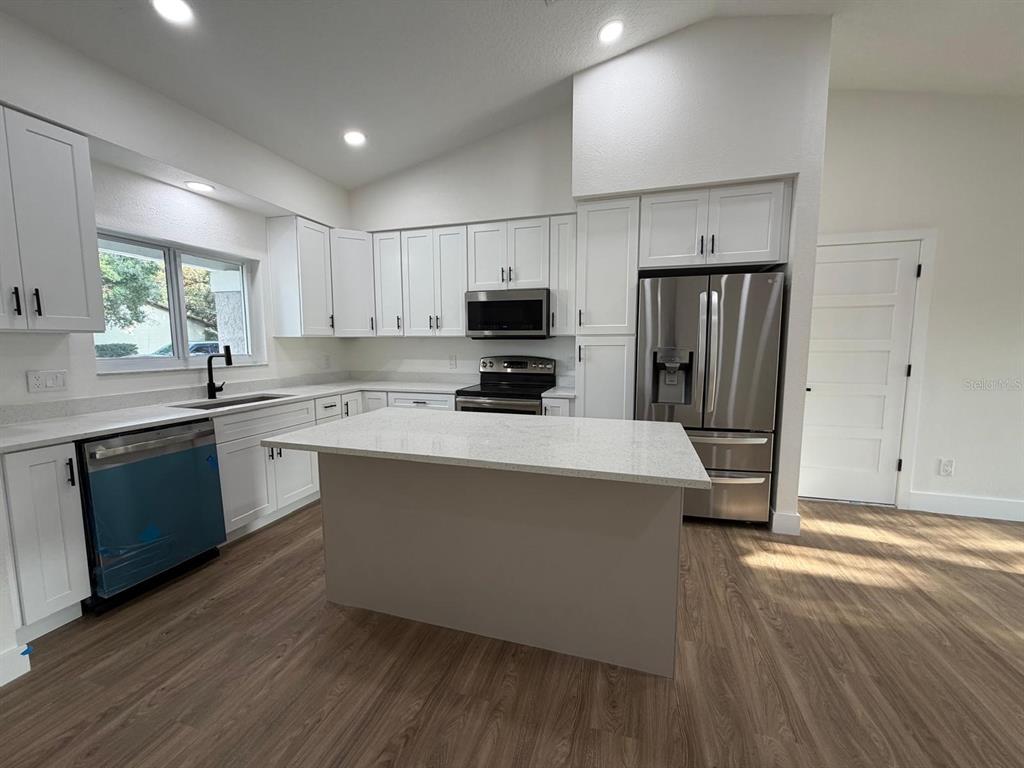 A single-story house with gray stucco, white siding, and a white garage door — 10722 WHISPERWOOD LANE, ORLANDO, FL
