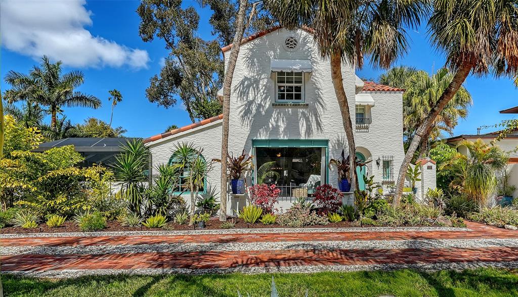 A white stucco house with a red tile roof and a brick driveway — 547 N SHORE DRIVE, SARASOTA, FL