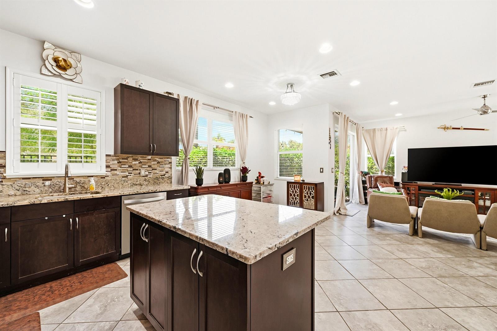 A laundry room features a washer and dryer set, wire shelving, and a window — 6993 Pines Circle, Coconut Creek FL 33073, COCONUT CREEK, FL