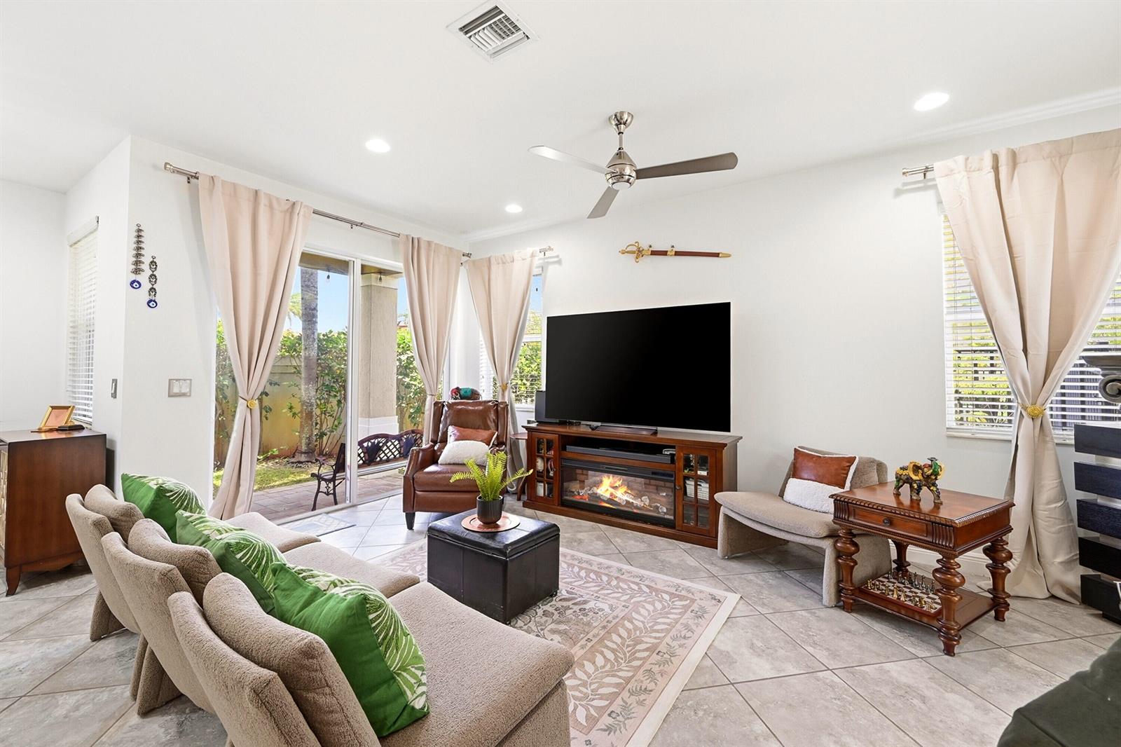 A two-story house with a paved driveway and palm trees at night — 6993 Pines Circle, Coconut Creek FL 33073, COCONUT CREEK, FL