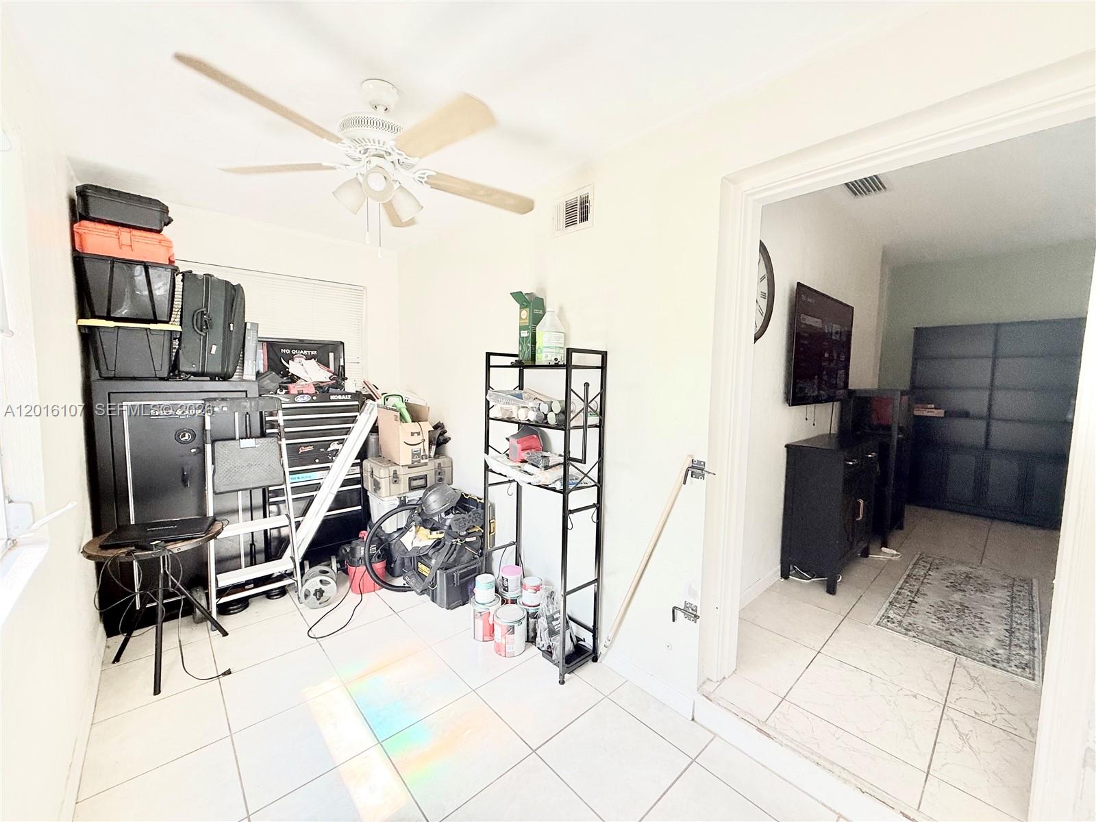 A small bathroom features a white vanity, a toilet, and a shower-tub combination — 825 S 20th Ave # A, Hollywood FL 33020, HOLLYWOOD, FL