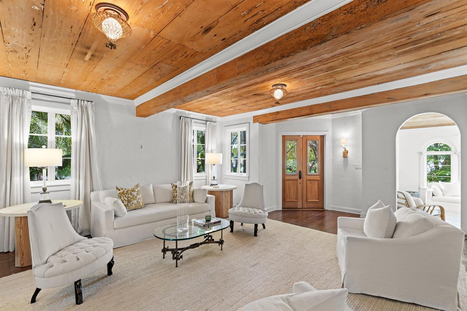 A bright living room features white furniture, a wood-plank ceiling, and an arched entryway — 746 Upland Road, West Palm Beach FL 33401, WEST PALM BEACH, FL
