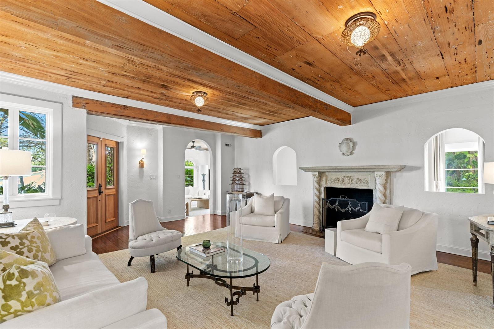 A living room features a wood-plank ceiling, white walls, a fireplace, and neutral furniture — 746 Upland Road, West Palm Beach FL 33401, WEST PALM BEACH, FL