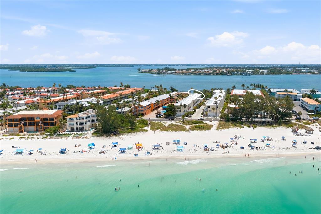 An aerial view of a beachside residential complex with white sand and turquoise water — 1473 GULF DRIVE N, BRADENTON BEACH, FL