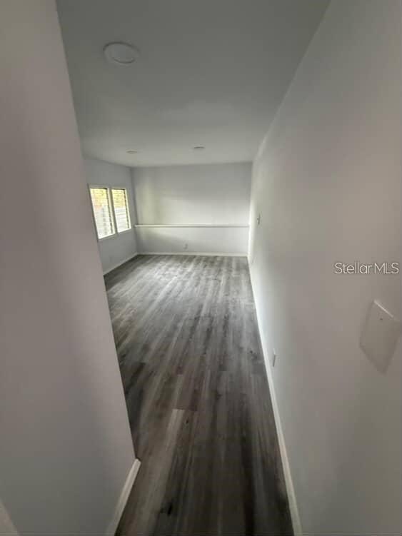 A hallway leads into a room with light gray walls and wood-look vinyl flooring — 5500 N ROME AVENUE UNIT 29, TAMPA, FL