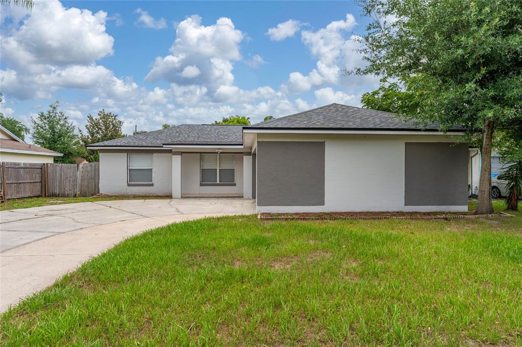 A single-story house with a gray and white exterior, a concrete driveway, and a lawn — 631 STANFORD DRIVE, ALTAMONTE SPRINGS, FL