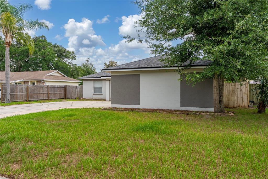 A single-story house with a white exterior, gray accents, and a concrete driveway — 631 STANFORD DRIVE, ALTAMONTE SPRINGS, FL