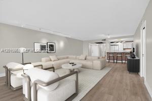 This is a digital rendering of a modern living room with a sectional sofa and chairs — 3090 N Course Dr # 807, Pompano Beach FL 33069, POMPANO BEACH, FL