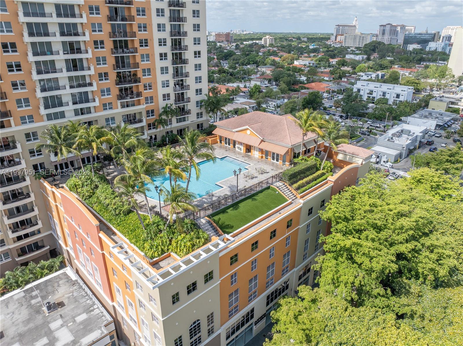 An aerial view shows a rooftop pool and garden terrace atop a multi-story building — 3232 SW 22nd Ter # 607, Miami FL 33145, MIAMI, FL