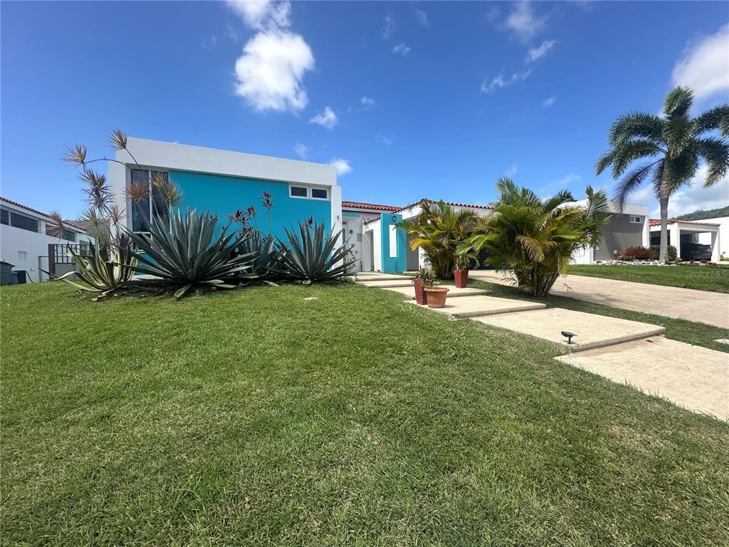 A bright blue modern house features a grassy lawn and a concrete walkway — 67 Los Sueños 67 LOS SUEÑ0S CIUDAD JARDIN, GURABO, PR