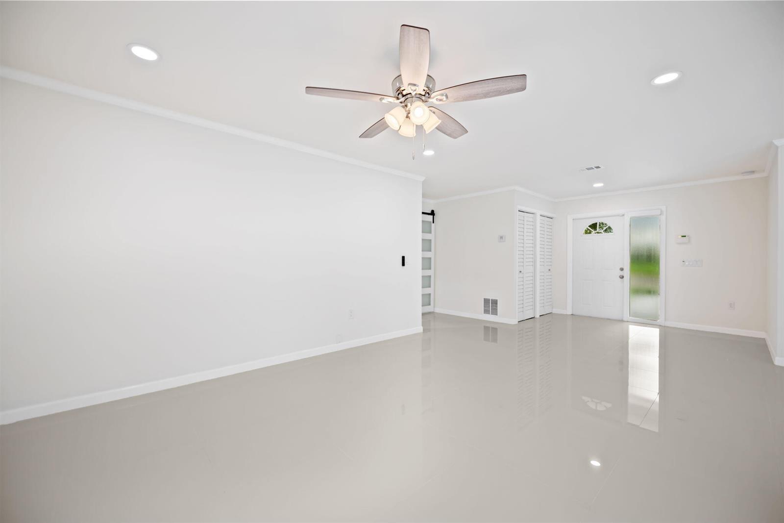 An empty room with white walls, glossy tile flooring, and a ceiling fan — 561 SW 168th Terrace, Weston FL 33326, WESTON, FL
