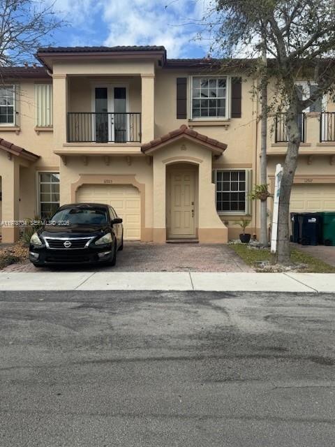A two-story townhouse with a black car parked in front of the entrance — 12923 SW 135th Ter, Miami FL 33186, MIAMI, FL