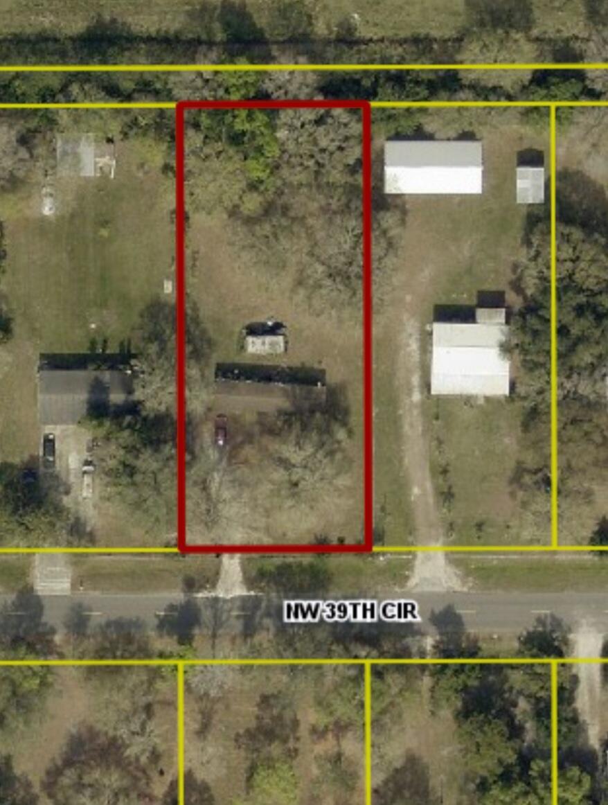 An aerial view shows a rectangular residential lot with a house and trees on it — 1469 NW 39th Circle, Okeechobee FL 34972, OKEECHOBEE, FL