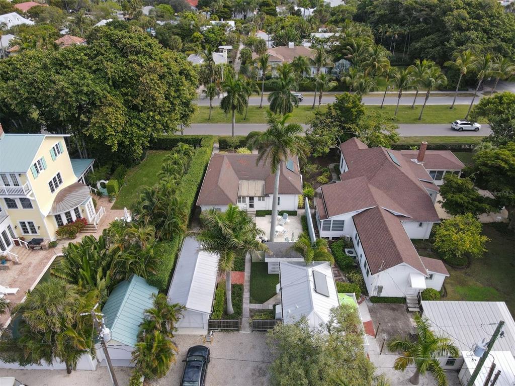 An aerial view shows several houses with brown roofs surrounded by lush tropical landscaping — 241 GILCHRIST AVENUE UNIT C, BOCA GRANDE, FL