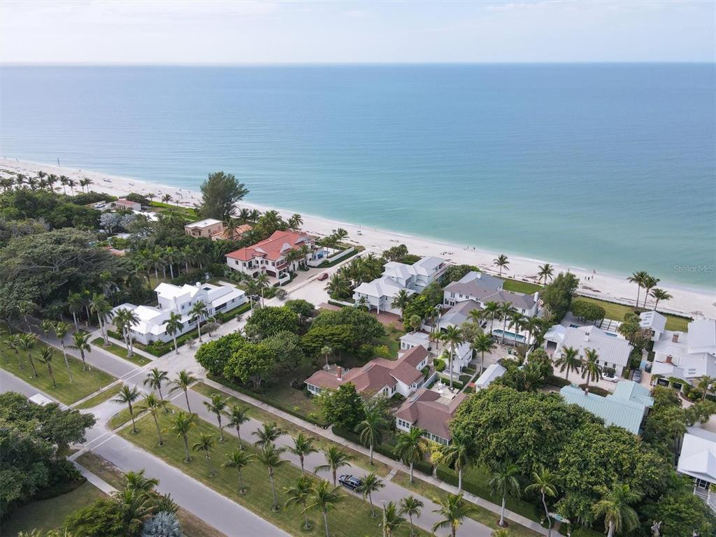 An aerial view shows coastal homes nestled among palm trees along a sandy beach — 241 GILCHRIST AVENUE UNIT C, BOCA GRANDE, FL