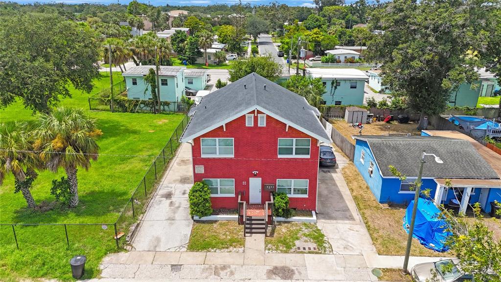 An aerial view shows a two-story red brick building with a gray roof and driveway — 1761 19TH STREET S, ST PETERSBURG, FL