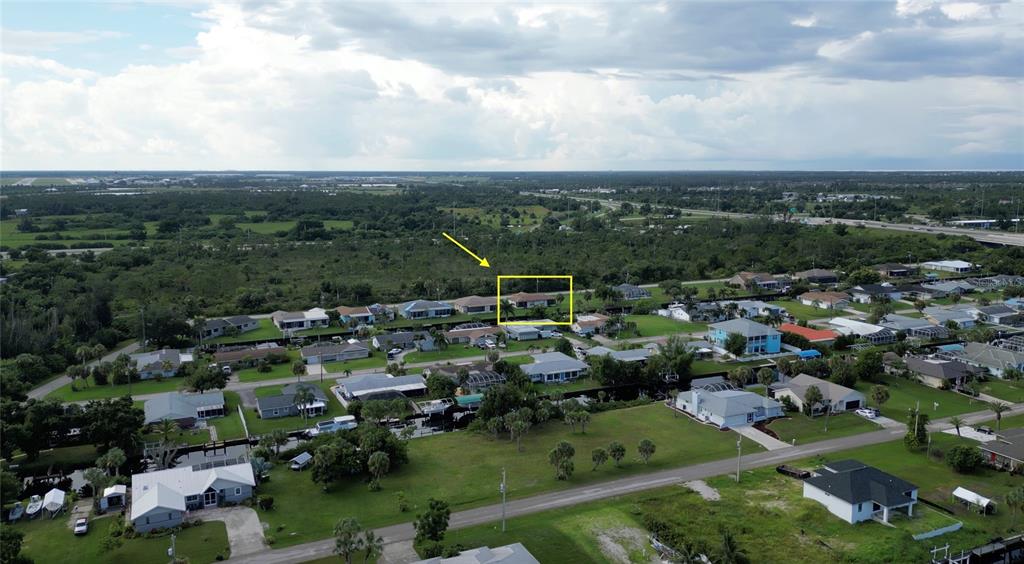 An aerial view shows a residential neighborhood with a yellow box highlighting a specific house — 3103 RIVERSIDE DRIVE, PUNTA GORDA, FL