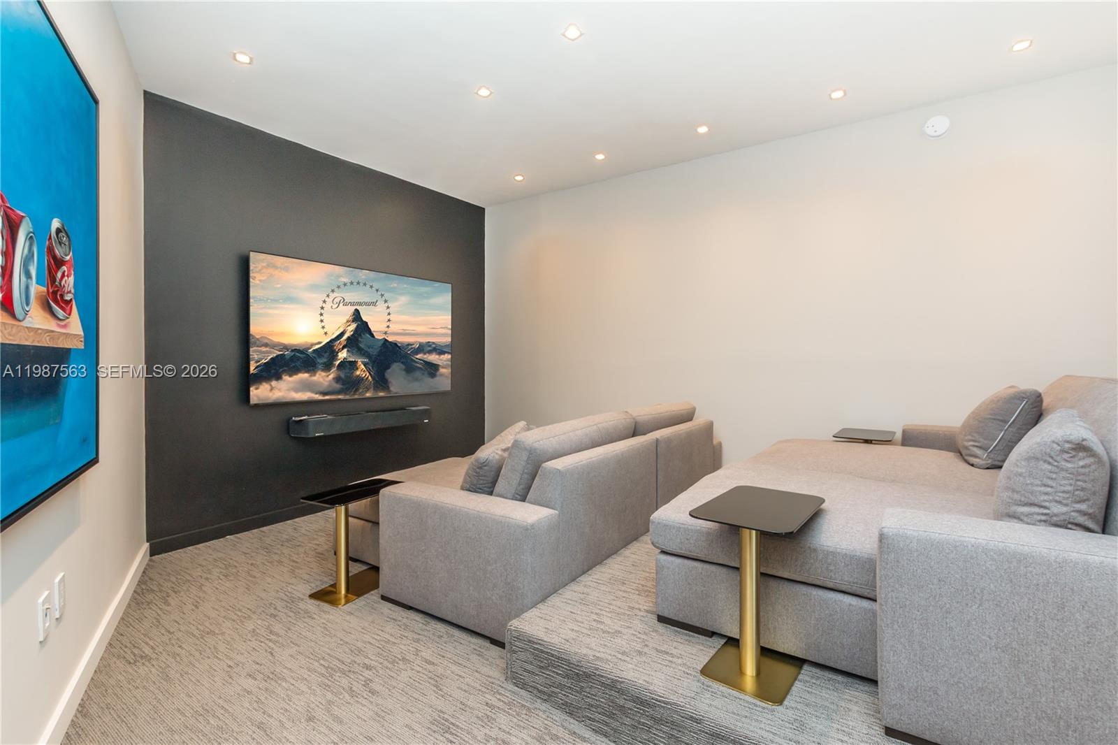 A home theater features a dark accent wall, tiered seating, and a wall-mounted television — 851 NE 1st Ave # 4611, Miami FL 33132, MIAMI, FL