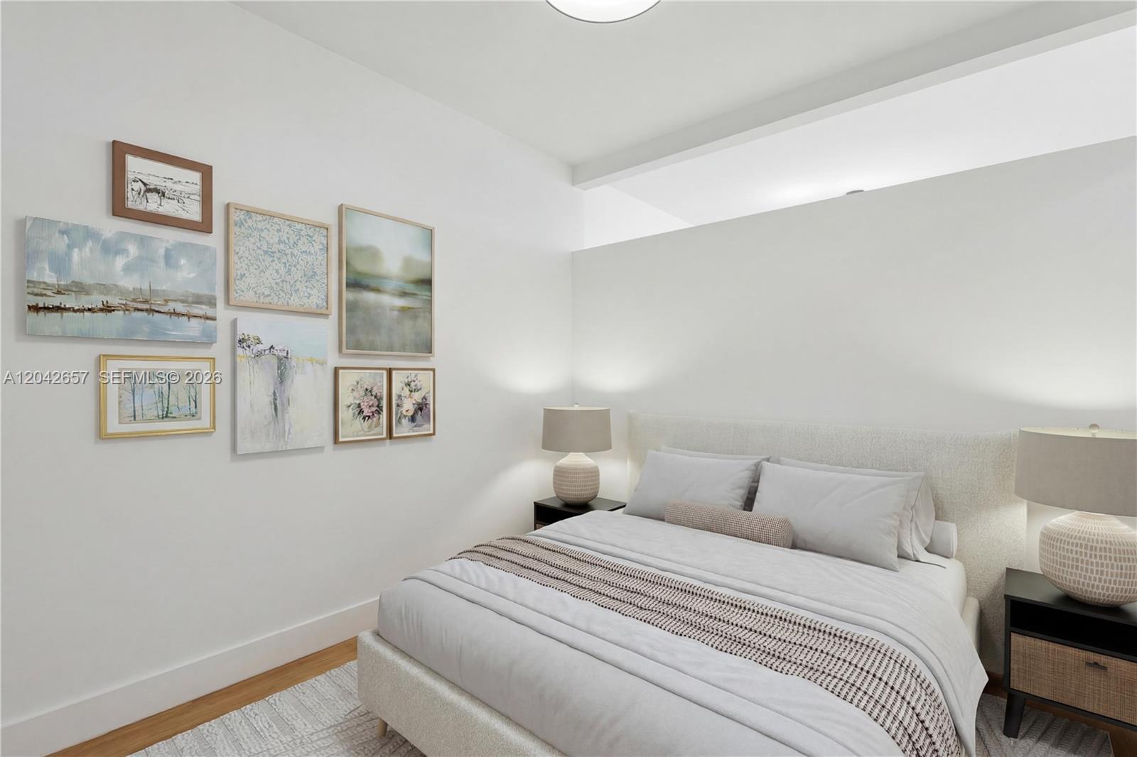 A bedroom features a bed with a gallery wall of framed art on the left — 650 NE 2nd Ave # 3412, Miami FL 33132, MIAMI, FL