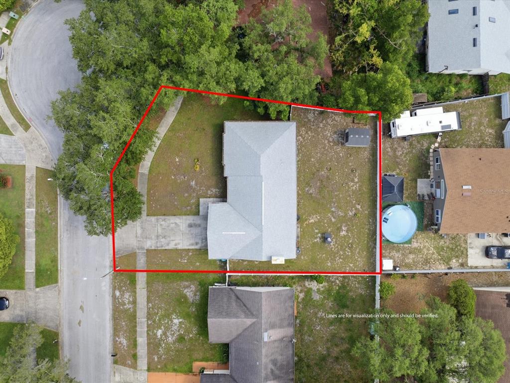 An aerial view shows a house with a gray roof and a fenced backyard — 5275 SIGNAL HILL ROAD, ORLANDO, FL