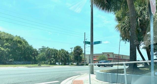 A street intersection with a road sign, palm trees, and a commercial building in the background — 726 CORDOVA DRIVE, ORLANDO, FL