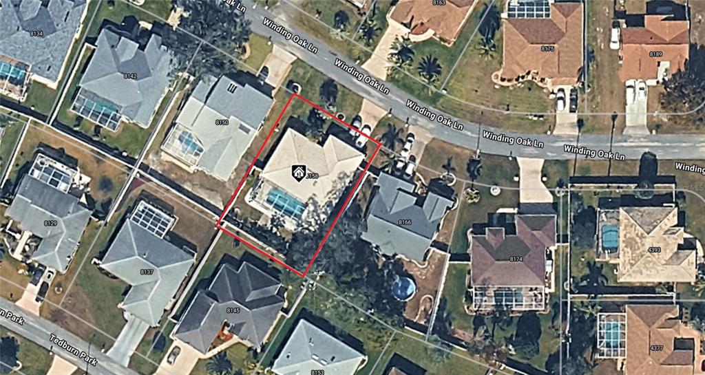 This is an aerial map view of a residential property highlighted in red — 8158 WINDING OAK LANE, SPRING HILL, FL