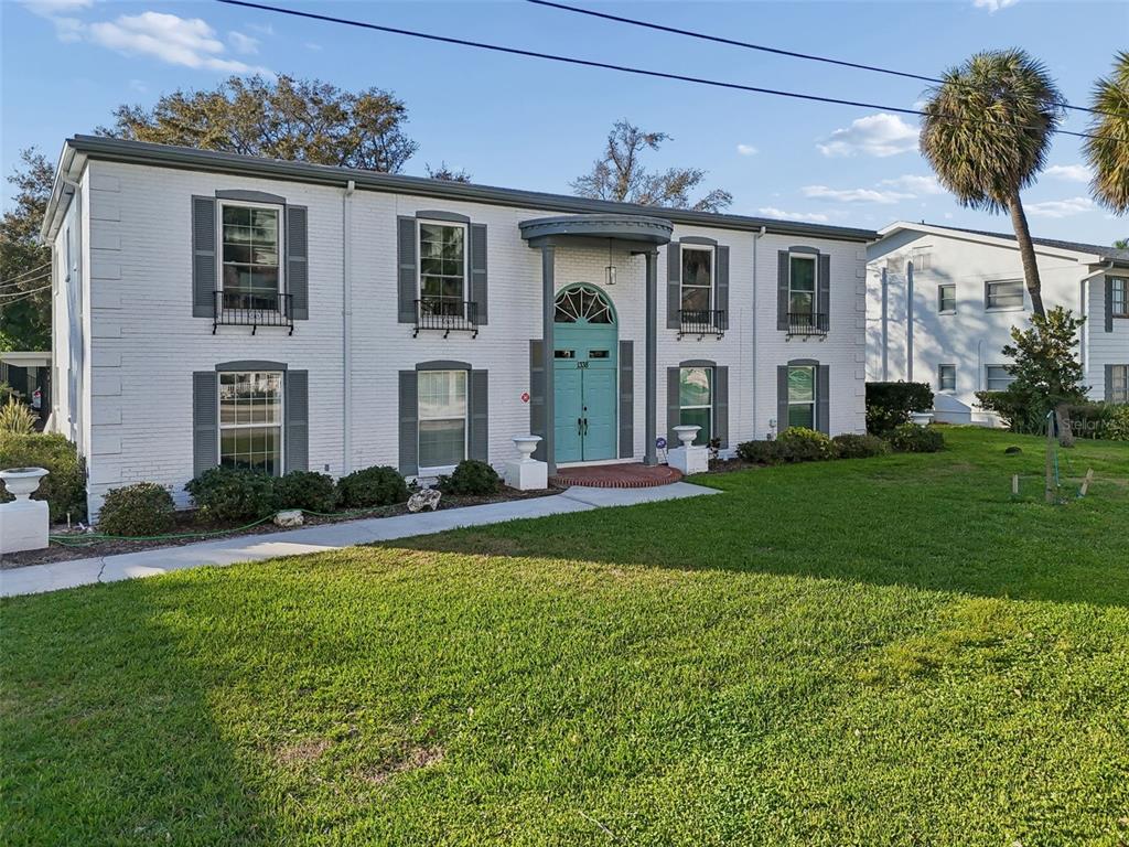 A two-story white brick building features a teal front door and gray window shutters — 1338 SNELL ISLE BOULEVARD NE UNIT 2, ST PETERSBURG, FL