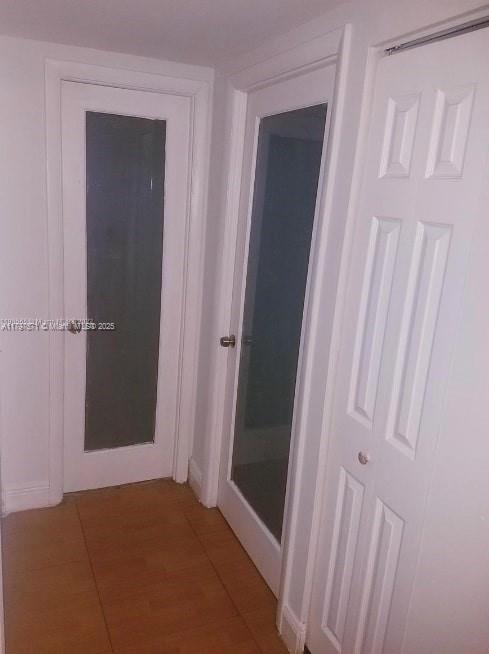 A hallway features two doors with glass panels and a white bi-fold closet door — 15600 NW 7th Ave # 319, Miami FL 33169, MIAMI, FL