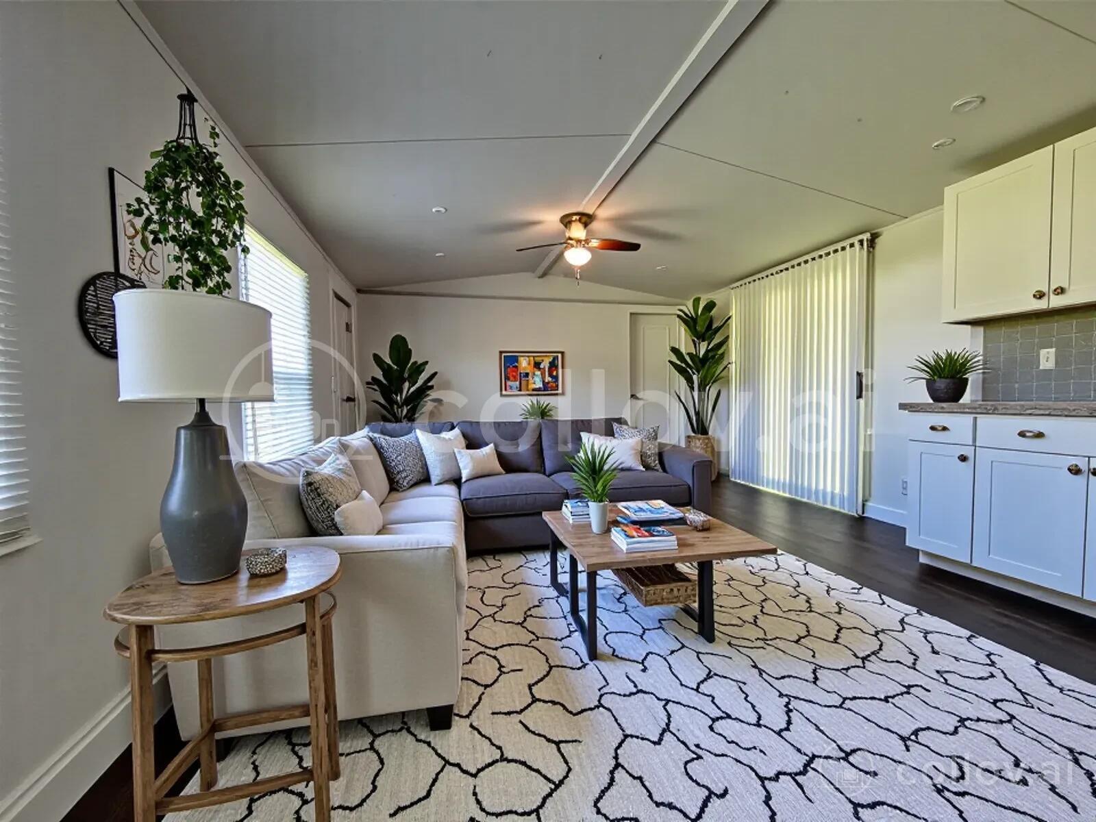 A living room features a sectional sofa, a coffee table, and a rug on wood flooring — 585 NW Avenue D, Moore Haven FL 33471, MOORE HAVEN, FL