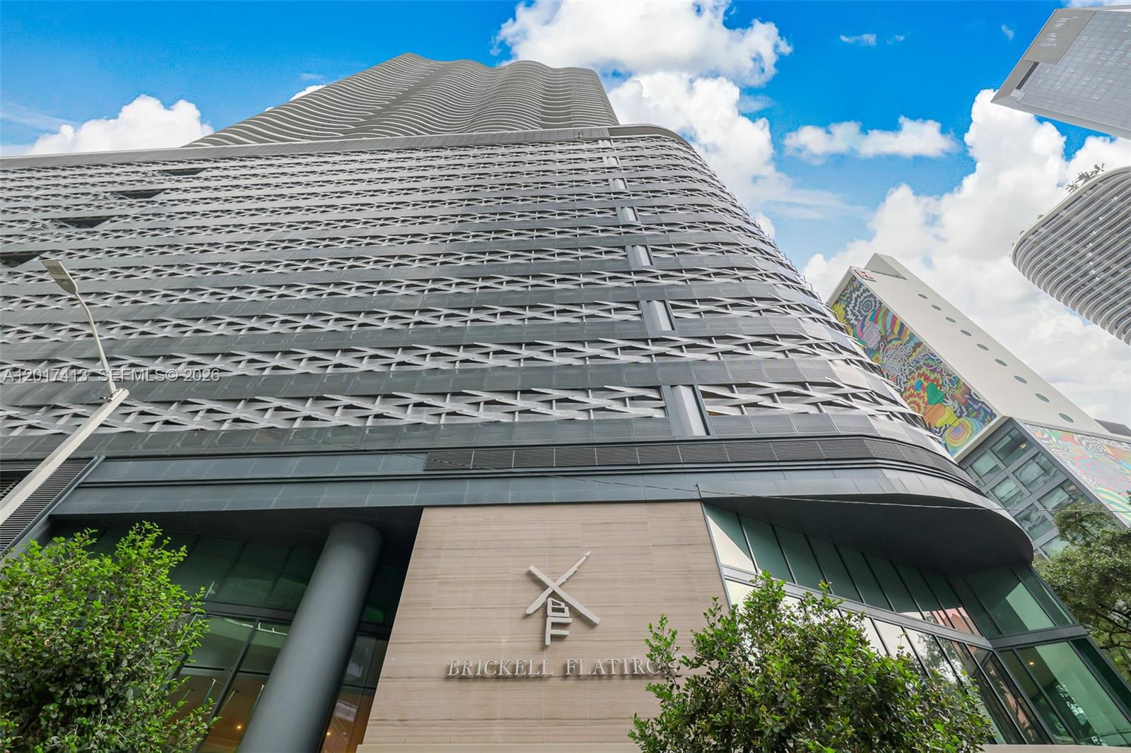 A low-angle view of the Brickell Flatiron skyscraper exterior featuring a patterned metal facade — 1000 Brickell Plz # 3002, Miami FL 33131, MIAMI, FL