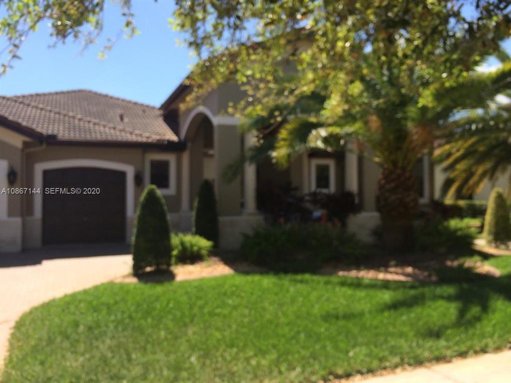 A single-story house with a garage and a palm tree in the front yard — 19080 SW 24th Street, Miramar FL 33029, MIRAMAR, FL