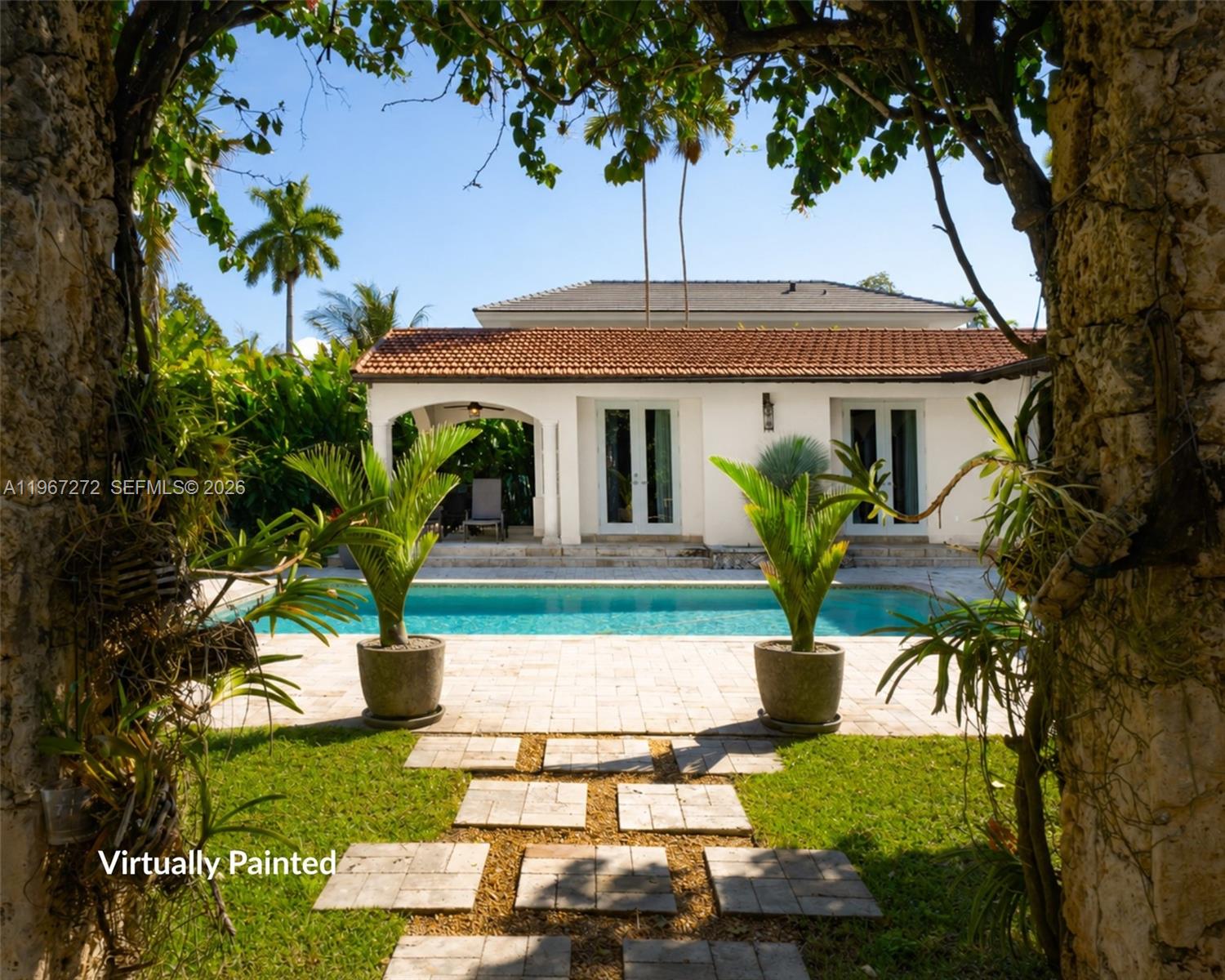 A two-story house with a red tile roof overlooks a backyard pool and lawn — 4867 SW 82nd St, Miami FL 33143, MIAMI, FL