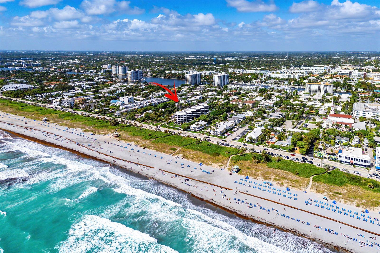 Aerial view of a multi-story beachfront condominium complex along a sandy coastline — 1108 Coconut Row, Delray Beach FL 33483, DELRAY BEACH, FL