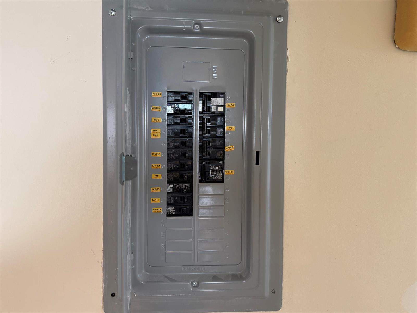 A gray electrical breaker panel is mounted on a beige wall — 47 Preston B # 47, Boca Raton FL 33434, BOCA RATON, FL