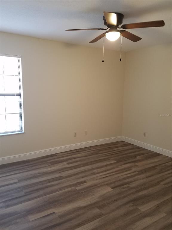 An empty bedroom features light-colored walls, a ceiling fan, and wood-look flooring — 505 BOXELDER AVENUE, ALTAMONTE SPRINGS, FL