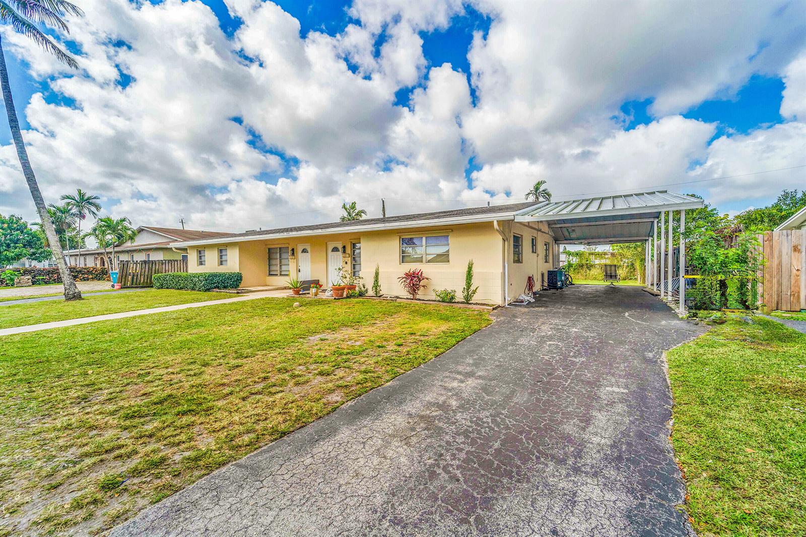 A single-story house with a yellow exterior, a front lawn, and a paved carport — 4681 SW 43rd Terrace # 2, Dania Beach FL 33314, DANIA BEACH, FL